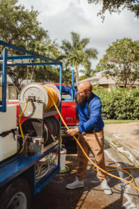 Professional roof cleaning team in Fort Myers using soft-wash methods to clean a residential home