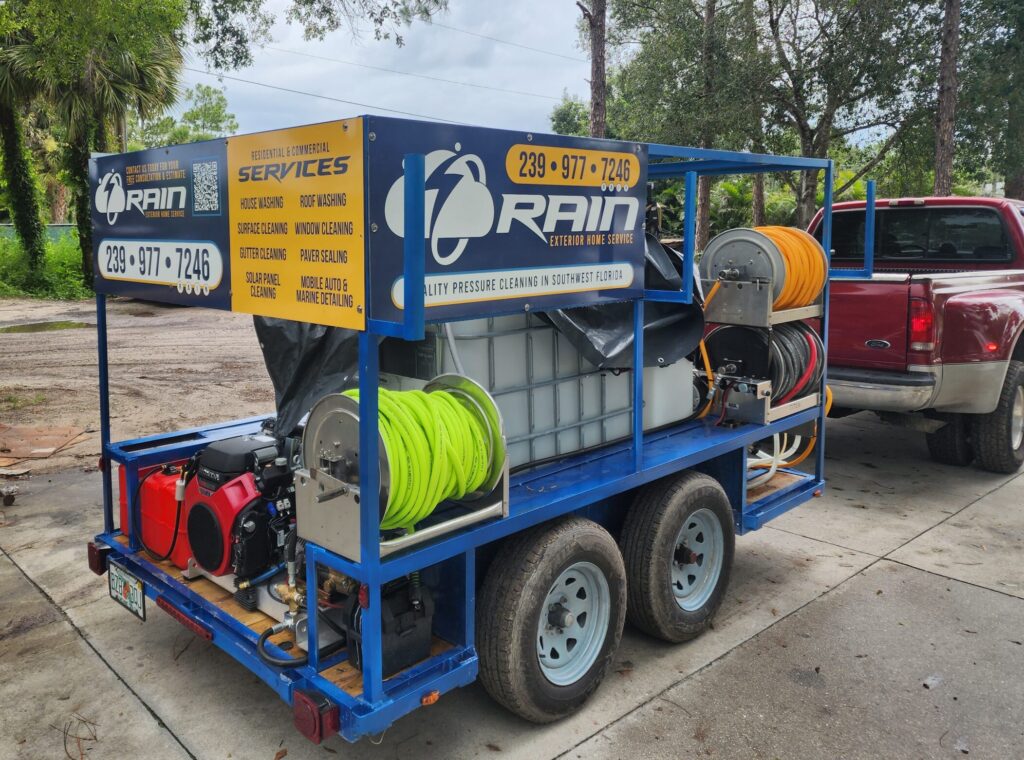 Multiple hose reels mounted on the pressure washing trailer for efficient cleaning.