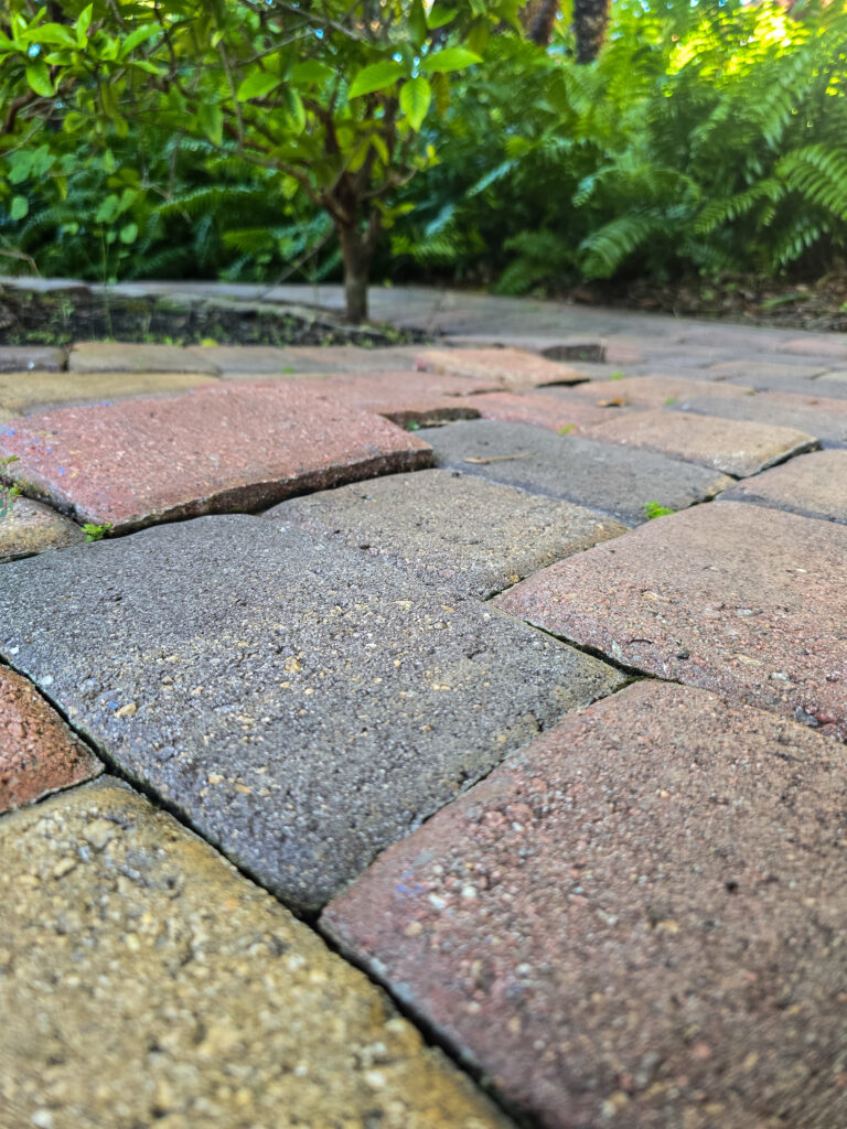 Shifting pavers caused by erosion, which can be prevented by proper sealing.