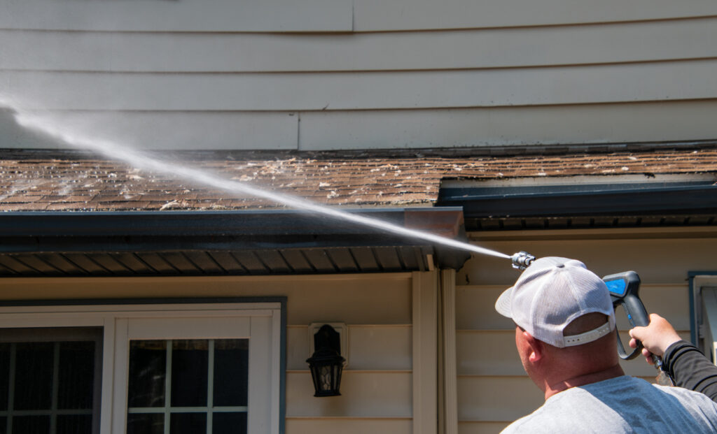 Soft washing a roof in Fort Myers to remove algae and extend lifespan.